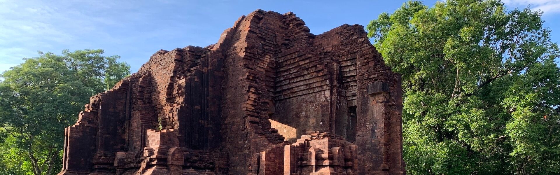 My Son’s serene Cham architecture in Vietnam on a My Son Travel banner by Legend Travel Group.